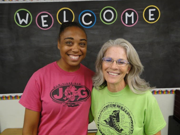 Teachers welcome in front of blackboard